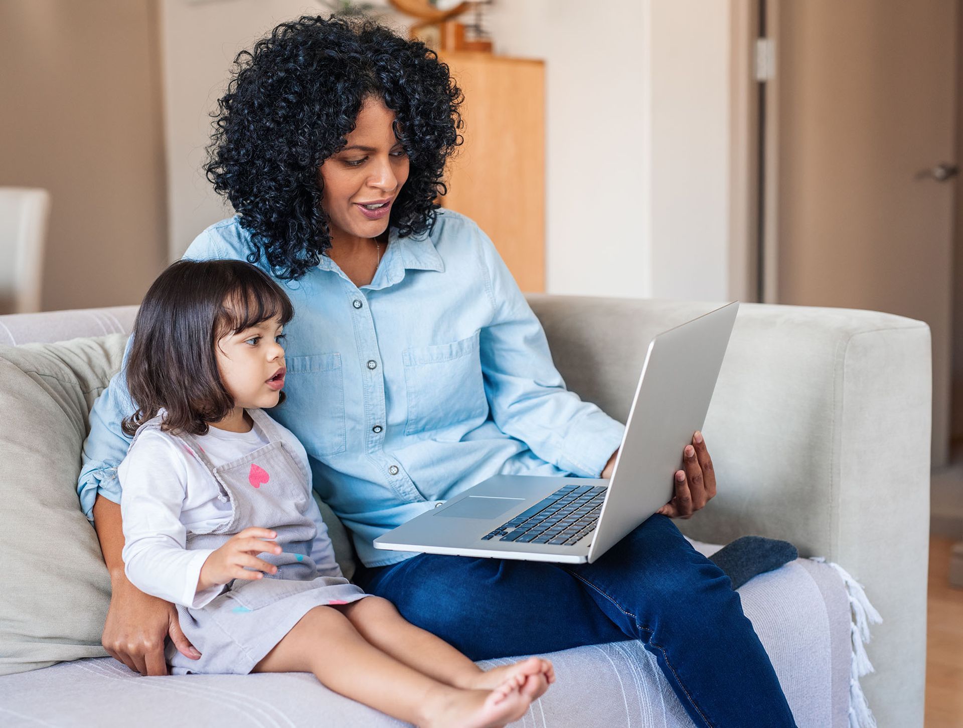 mother and daughter on laptop together at home doing a virtual medical visit