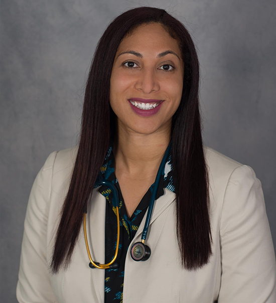 Portrait of Dr Monique Mondesir wearing a white coat