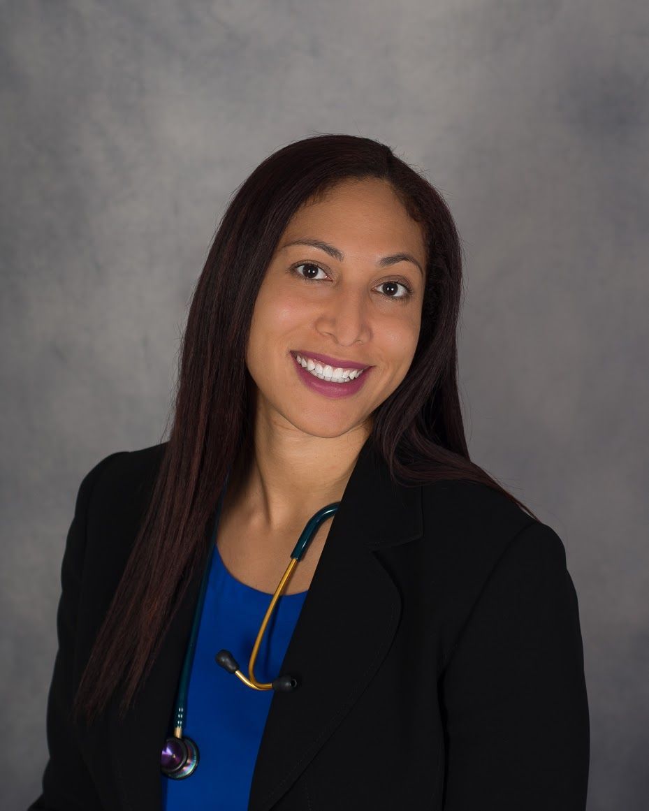 Portrait of DR. MONIQUE MONDESIR wearing a black coat