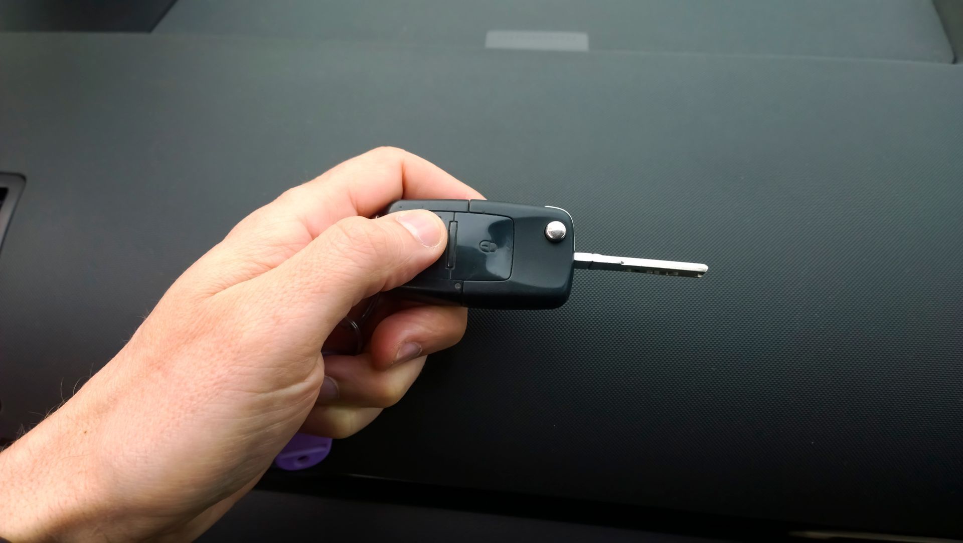 A Person Is Holding a Car Key in Their Hand | Westminster, CO | M.L. Locksmith
