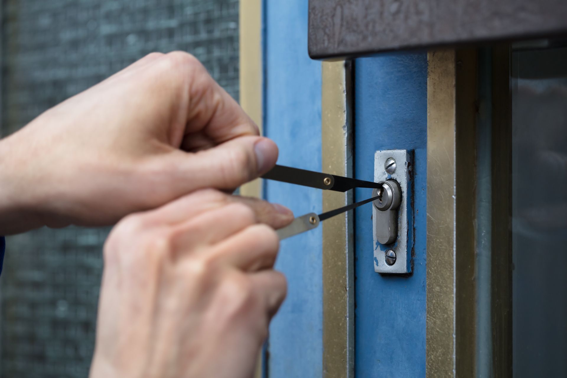 A Person Is Using a Screwdriver to Open a Door Lock | Westminster, CO | M.L. Locksmith A Person Is Using a Screwdriver to Open a Door Lock | Westminster, CO | M.L. Locksmith