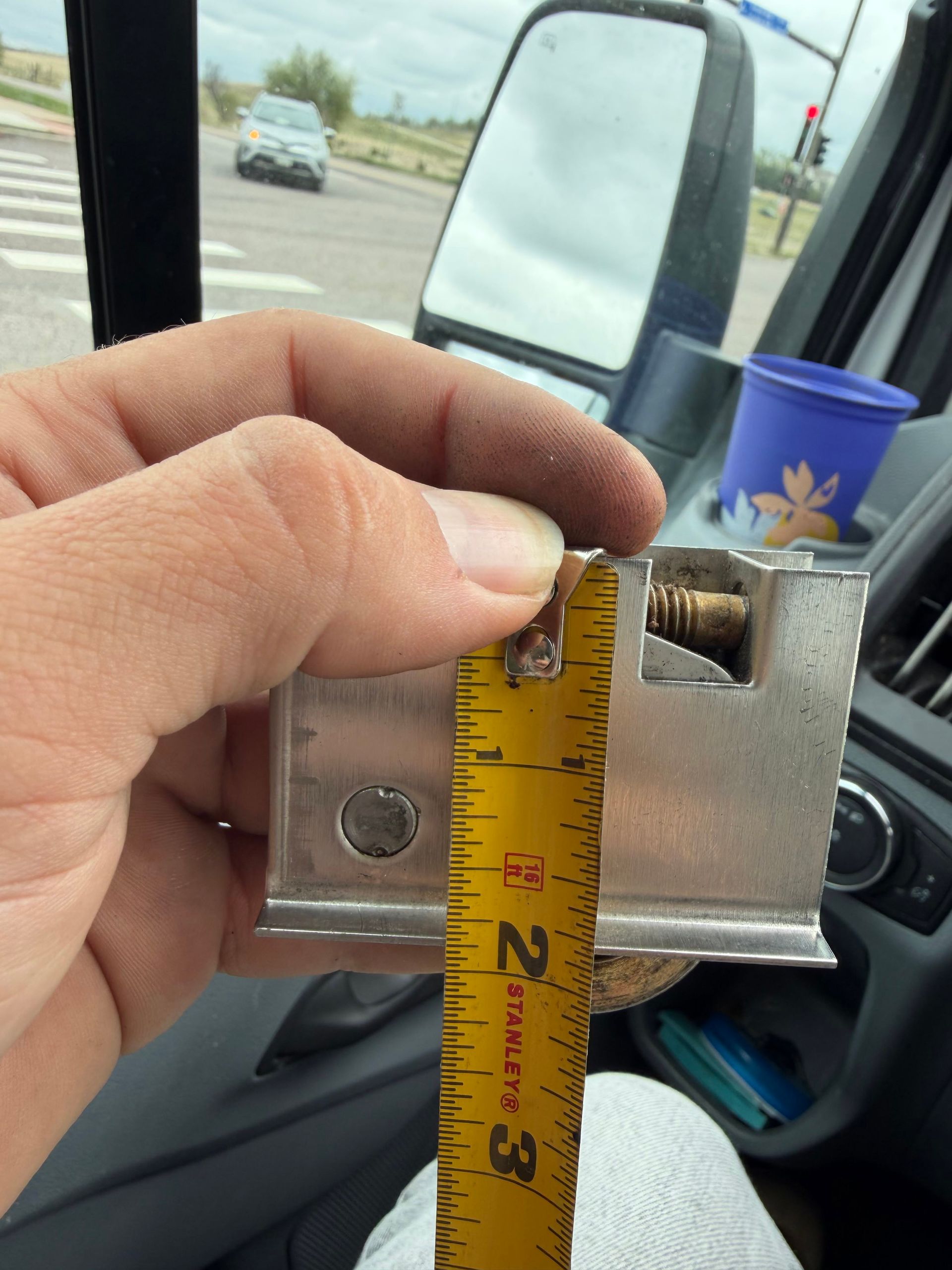 Sliding glass door track repair in Denver, focusing on cleaning and aligning the metal track.