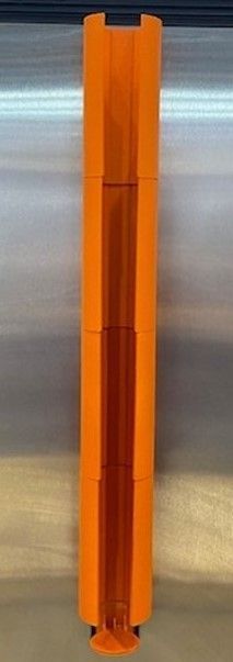 Orange, cylindrical, 3D-printed object, possibly a toy or prototype, on a metallic surface.