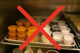 Tray of condiment cups marked with a red