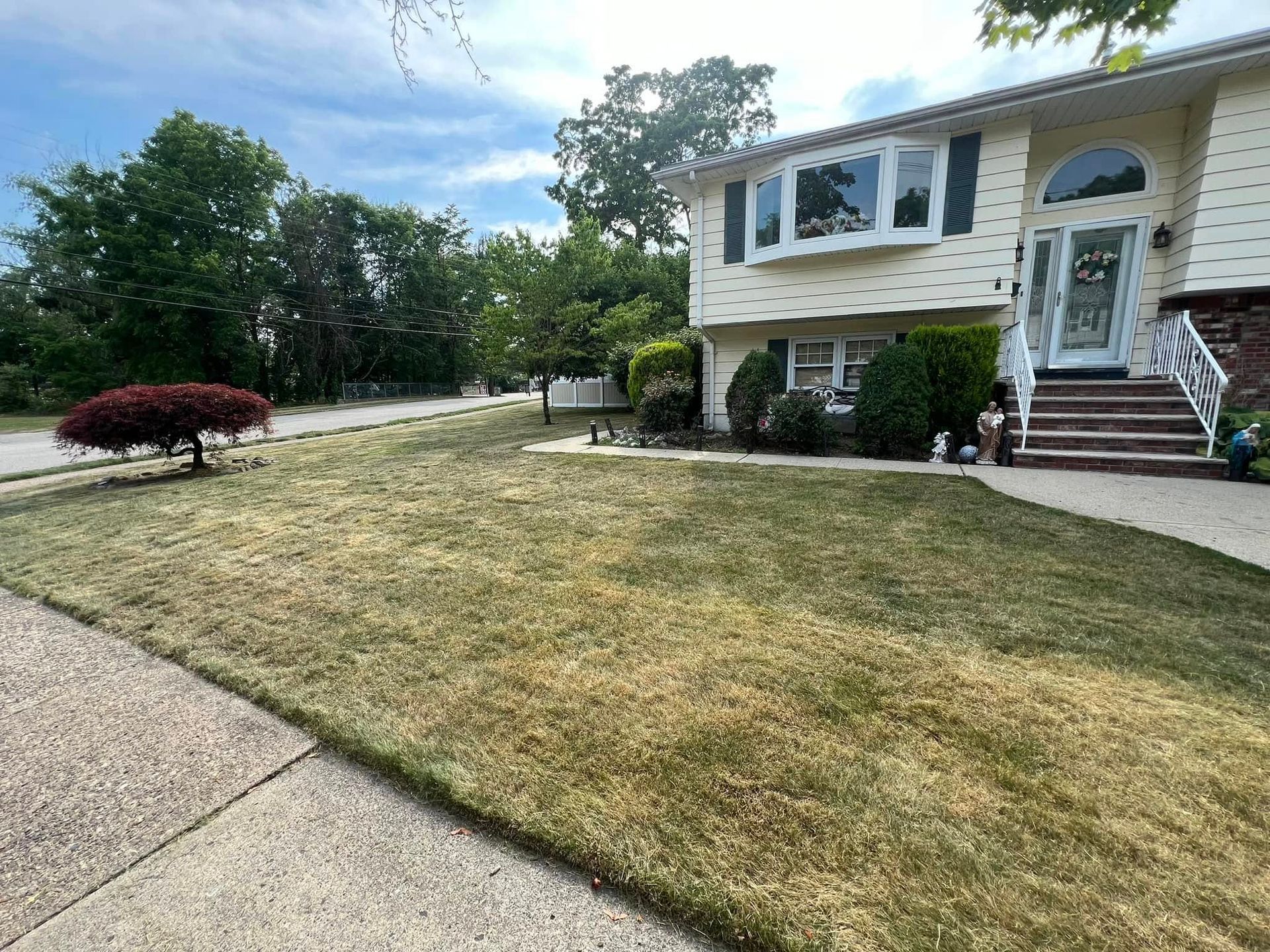 A large house with a lush green lawn in front of it.