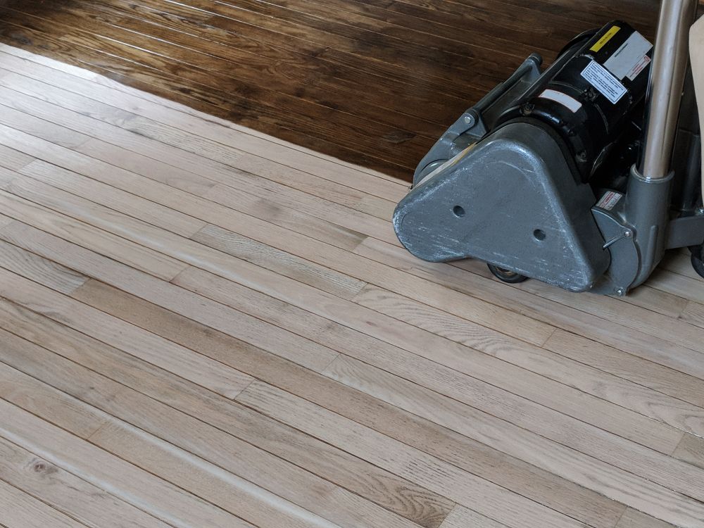 A Machine is Sitting on Top of a Wooden Floor — Norwood Floor Sanding in Tweed Heads, NSW