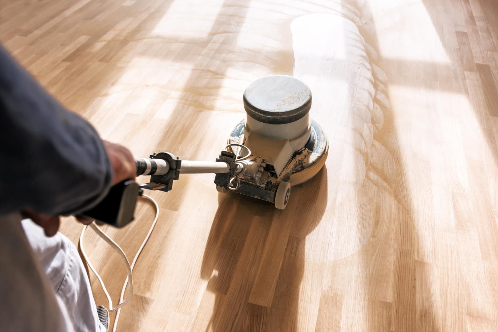 A Machine is Being Used to Polish a Wooden Floor — Norwood Floor Sanding in Ocean Shores, NSW