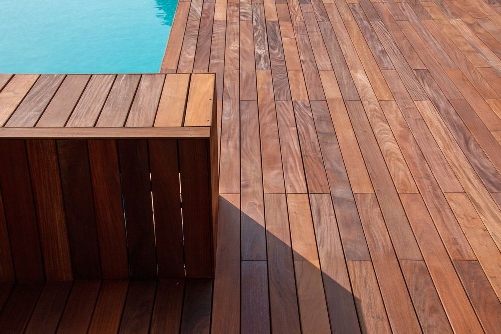 A Wooden Deck Next to a Swimming Pool — Norwood Floor Sanding in Ocean Shores, NSW