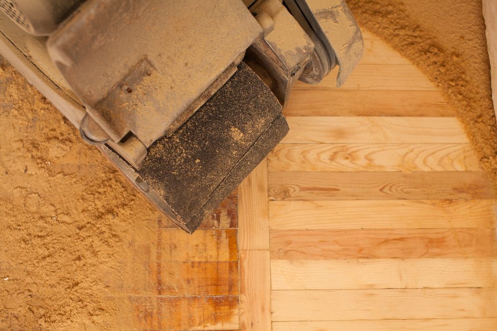 A Sander is Being Used to Sand a Wooden Floor — Norwood Floor Sanding in Byron Bay, NSW