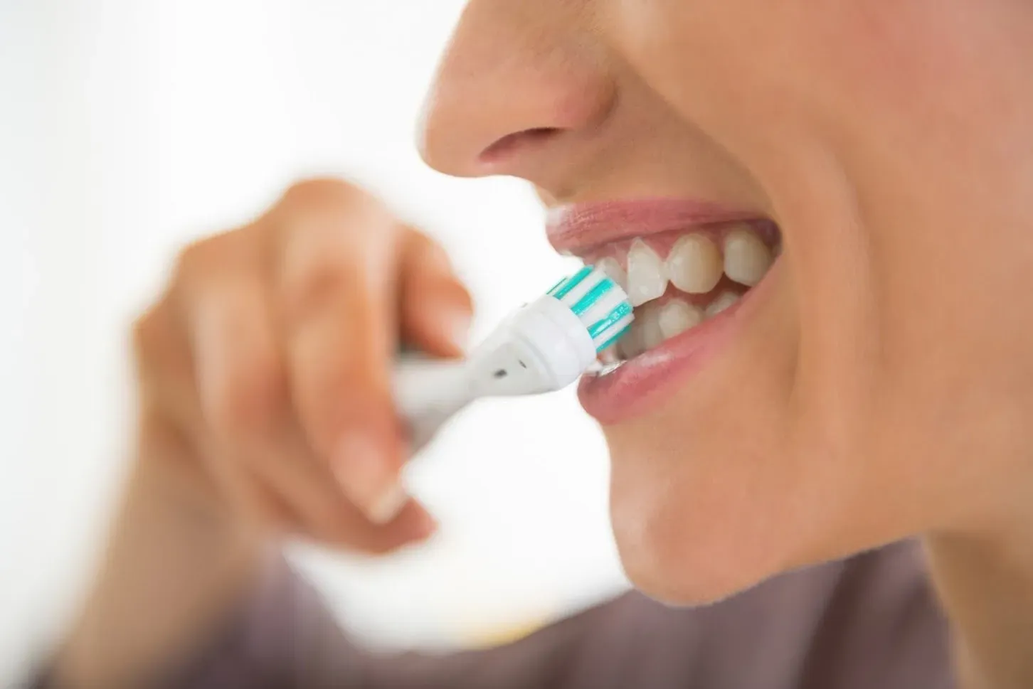 A Woman Brushing Her Teeth — Runcorn, QLD — Runcorn Dental