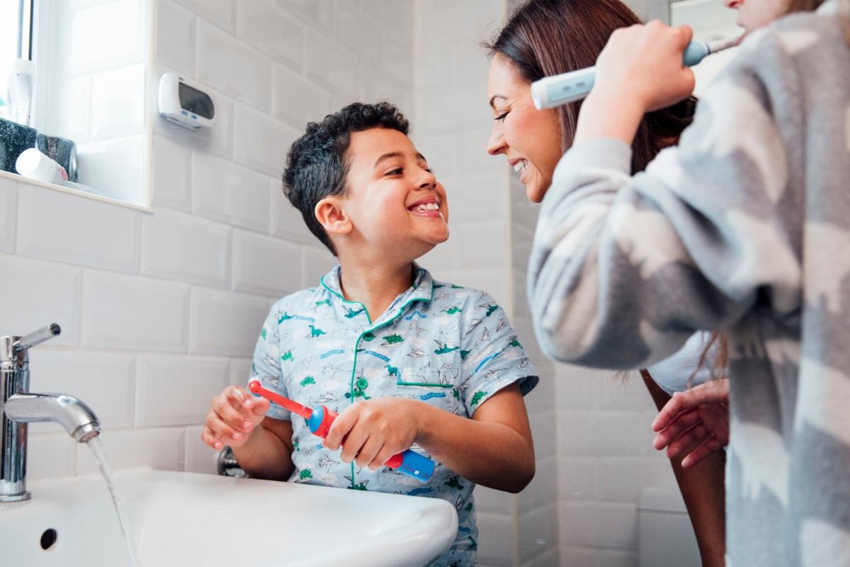 family brushing teeth together