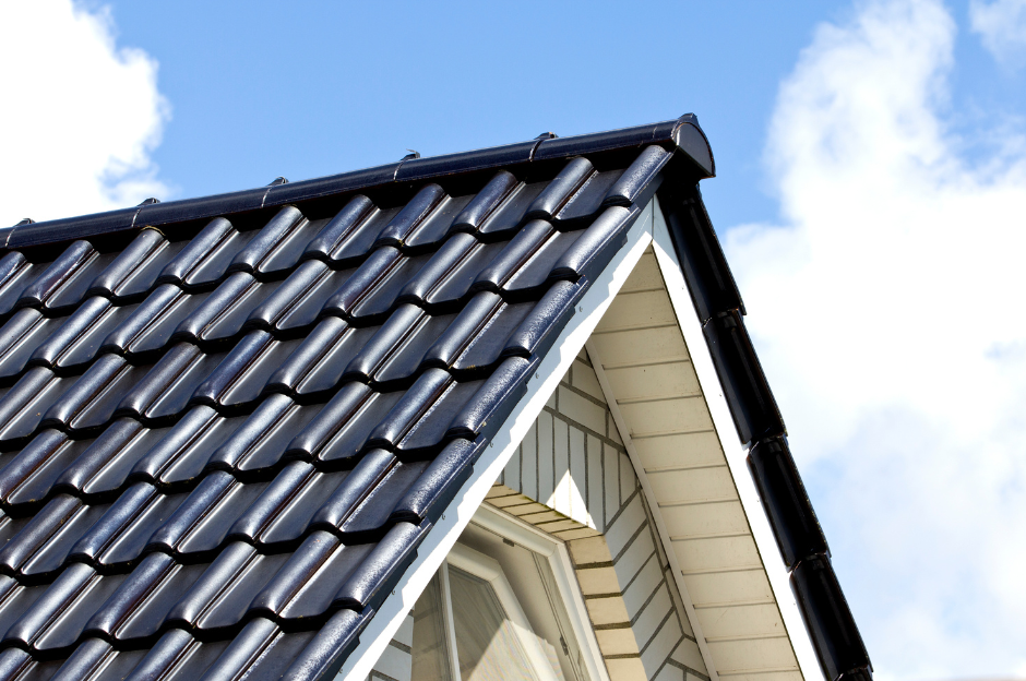 The roof of a house with a blue sky in the background