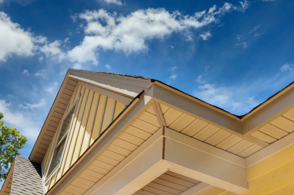 The roof of a house with a blue sky in the background