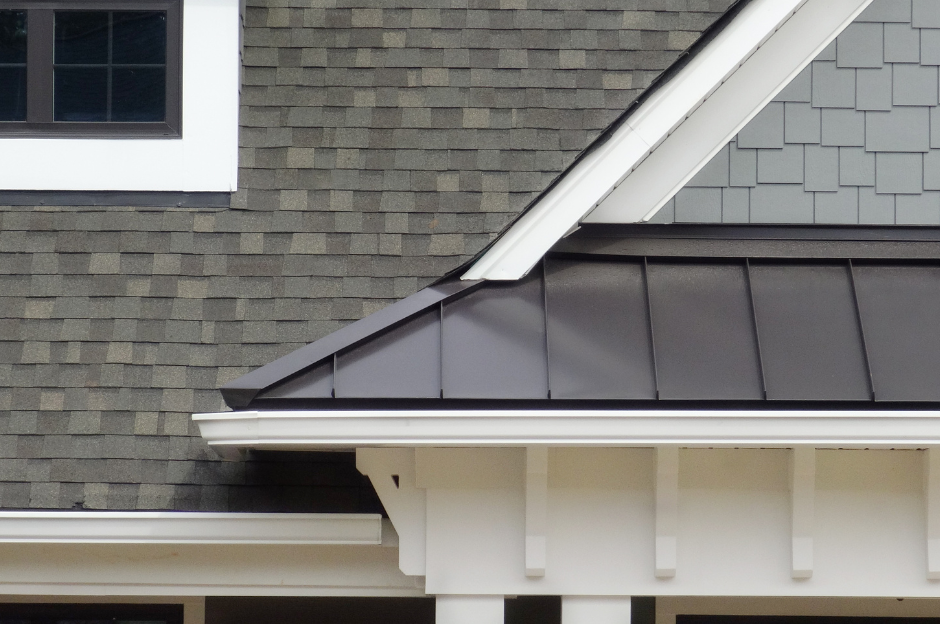 A close up of a house with a black roof