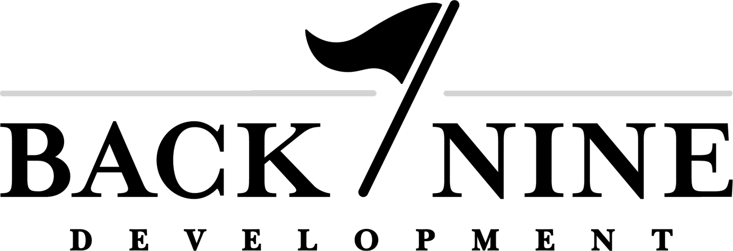 A black and white logo for back nine development with a flag.