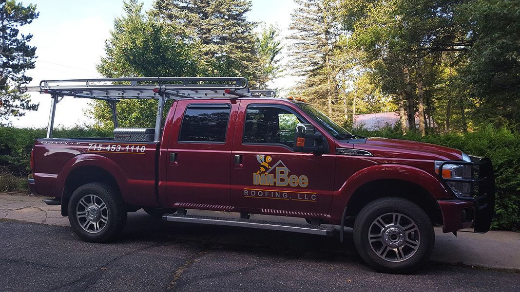 A red truck is parked on the side of the road.
