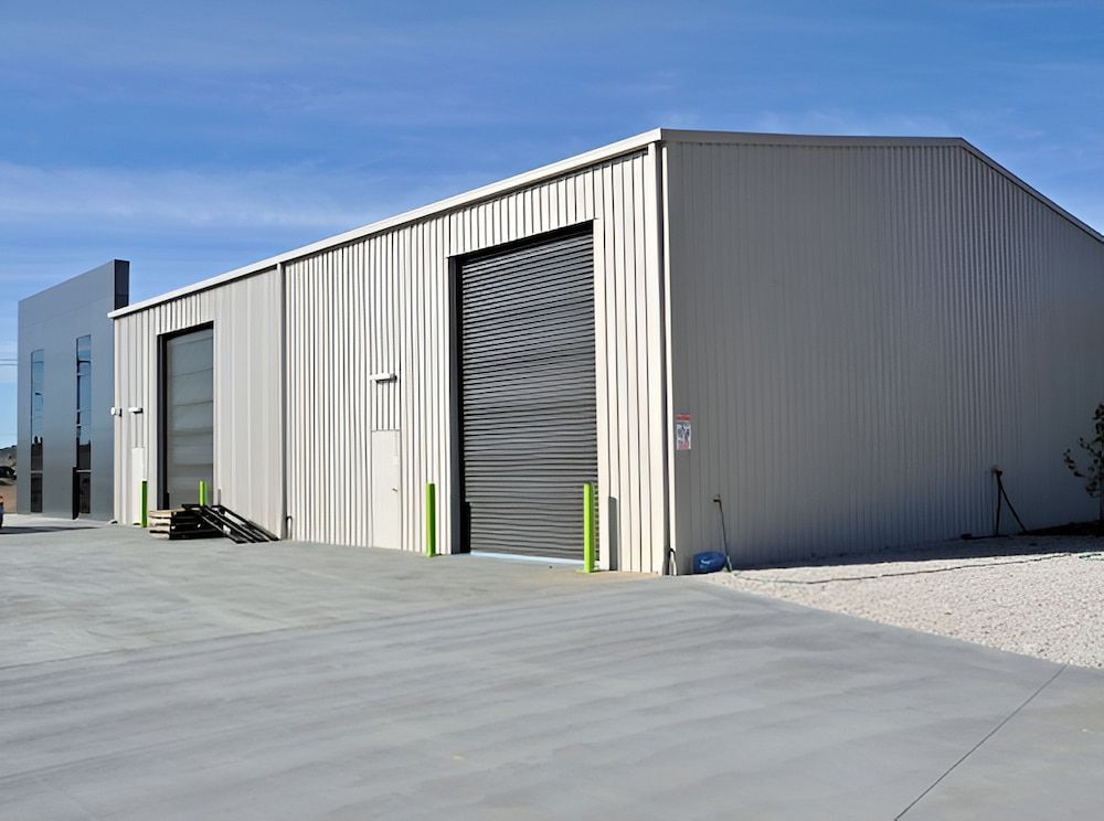 Metal Warehouse Building With Large Doors on a Concrete Lot — Northern Rivers Sheds in South Lismore, NSW