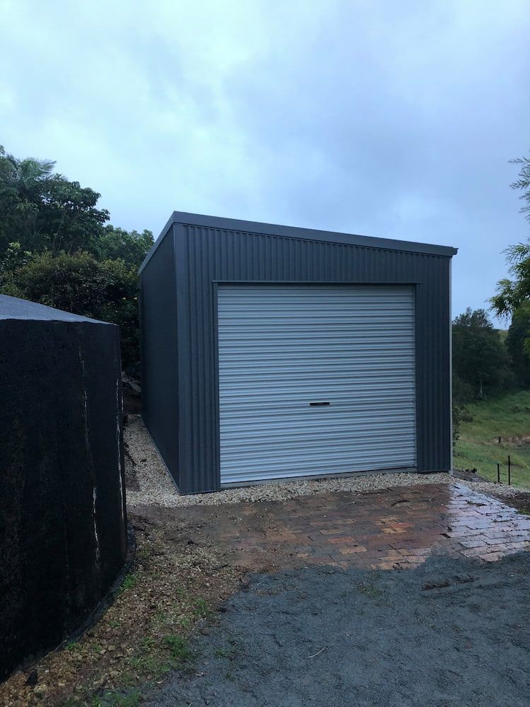 Gray Shed With a Sloping Roof and Closed Garage Door — Northern Rivers Sheds in South Lismore, NSW