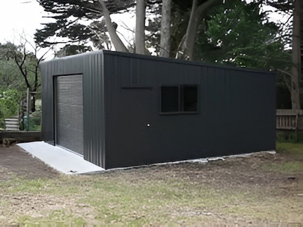 Dark Gray Shed With a Roll-up Door and a Window on a Concrete Base — Northern Rivers Sheds in South Lismore, NSW