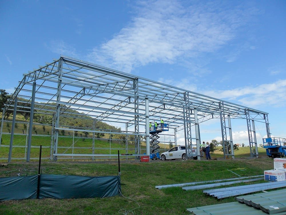 Steel Frame of a Building Under Construction in a Field on a Sunny Day — Northern Rivers Sheds in South Lismore, NSW