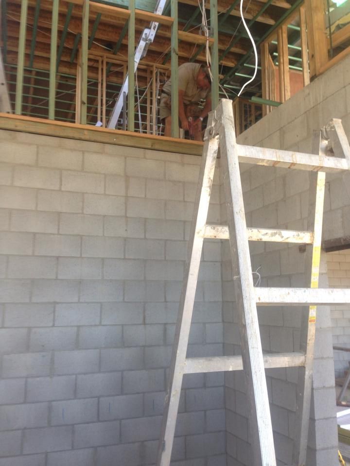 Construction Worker on Scaffolding Next to a Cinder Block Wall — All Pest QLD In Noosa, QLD