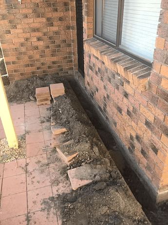 Trench Dug Along Brick Wall of a House — All Pest QLD In Sippy Downs, QLD