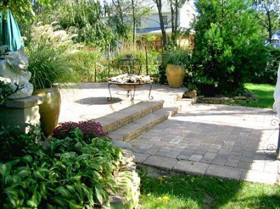 A patio with a fire pit in the middle of it