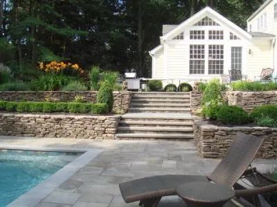A white house with a swimming pool in front of it