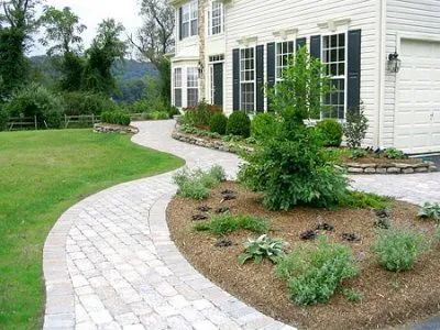A white house with a brick walkway leading to it