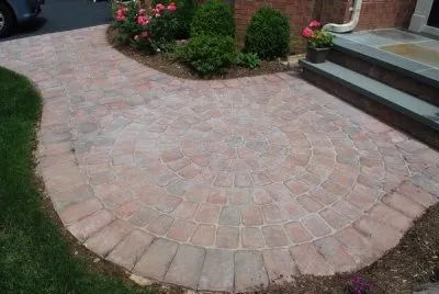 A brick walkway leading to the front door of a house.