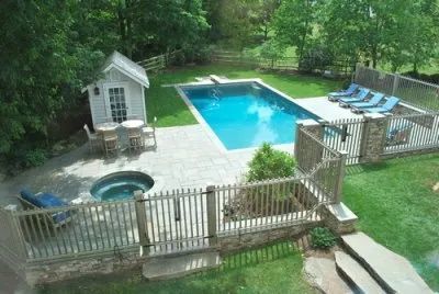 An aerial view of a backyard with a large swimming pool