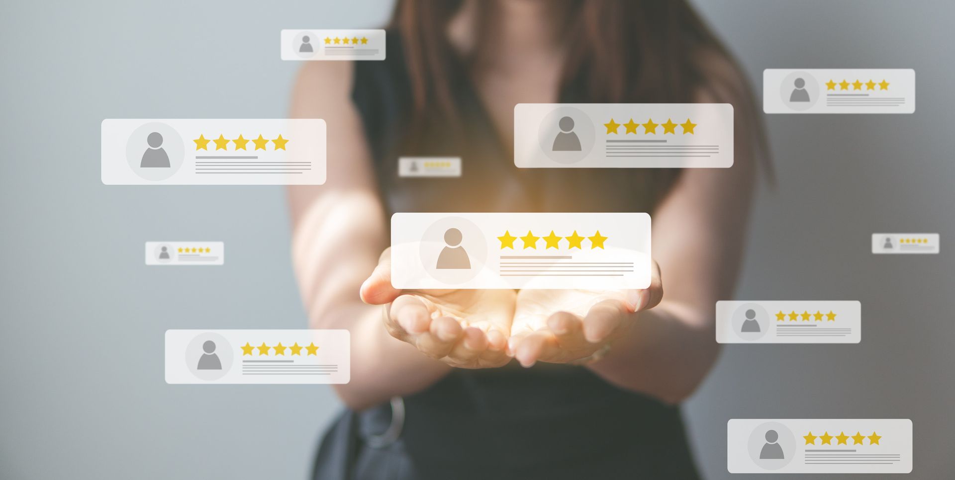 Hands cupped together with glowing review stars and customer rating icons floating above them