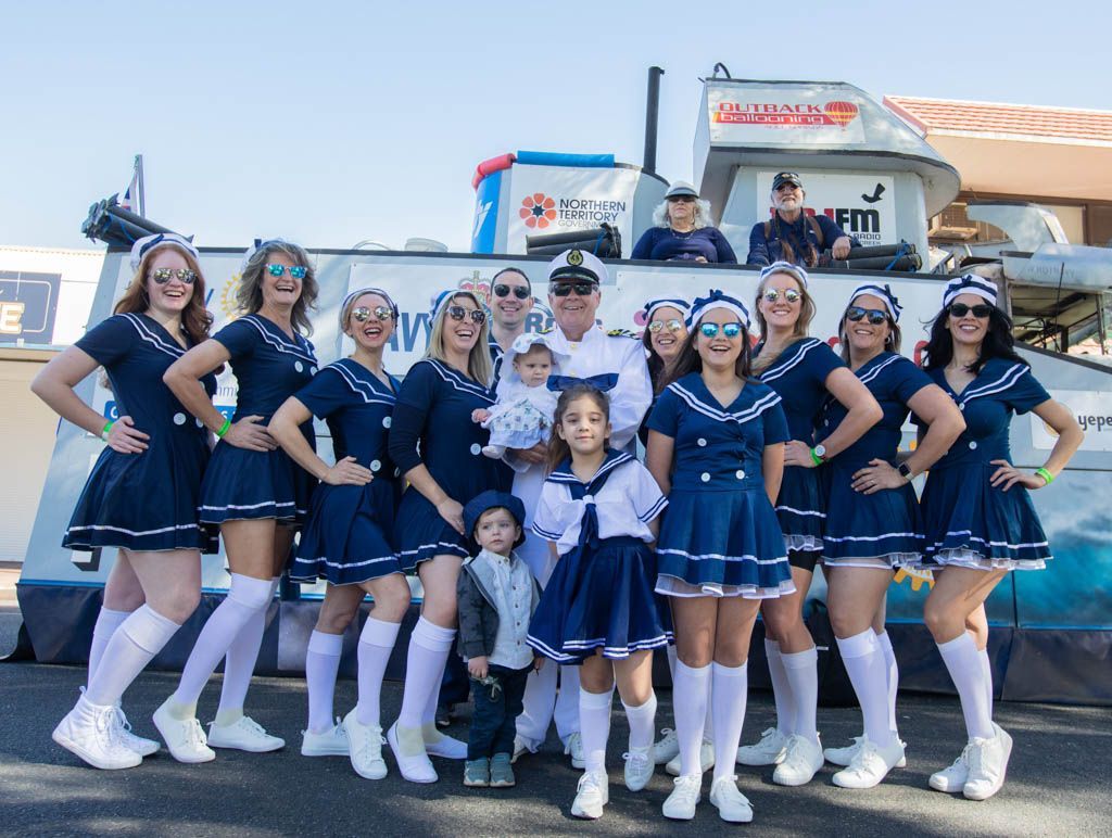 A group of people dressed in sailor costumes are posing for a picture.