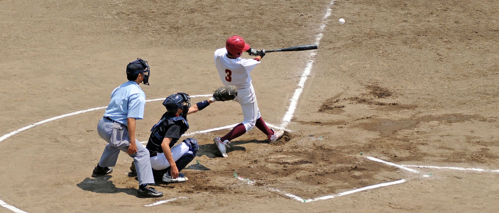 Baseball batter hitting ball