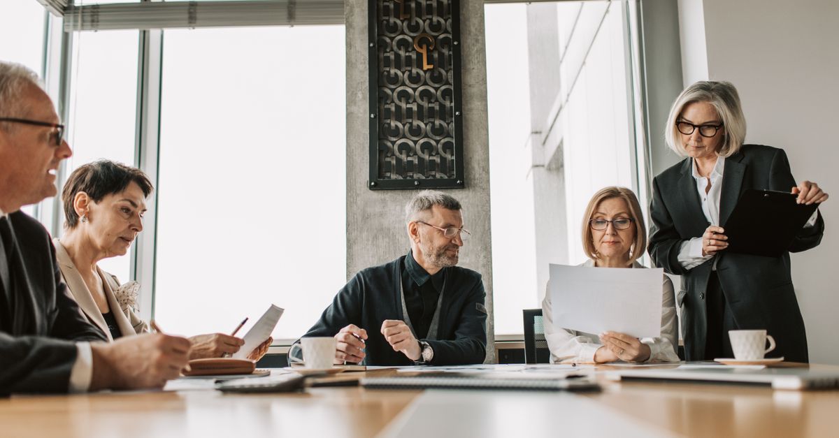 Founder and leadership team discussing decision rights in a modern boardroom