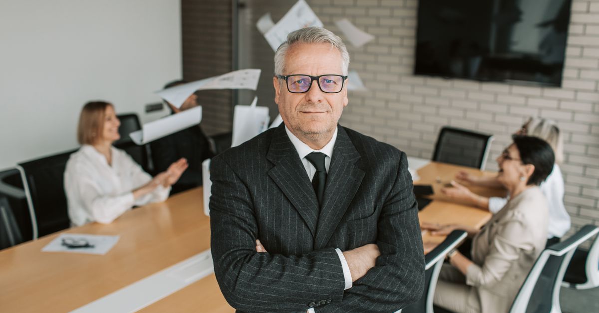 CEO empowering a diverse leadership team during a focused boardroom discussion