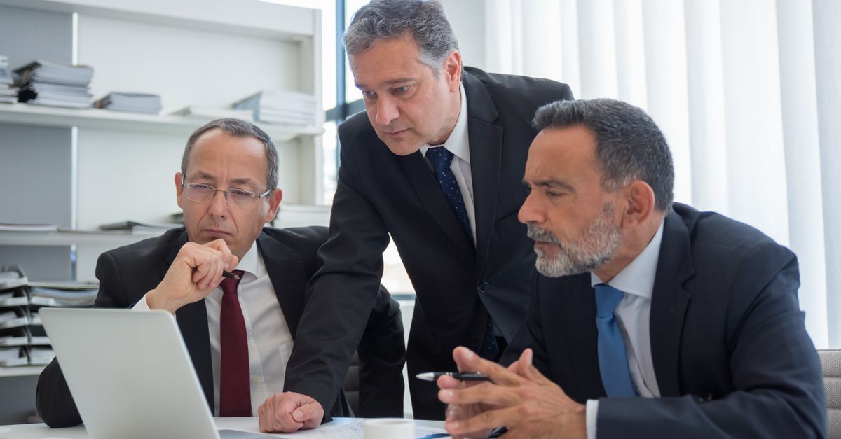 Executive leadership team discussing decision rights in a modern boardroom
