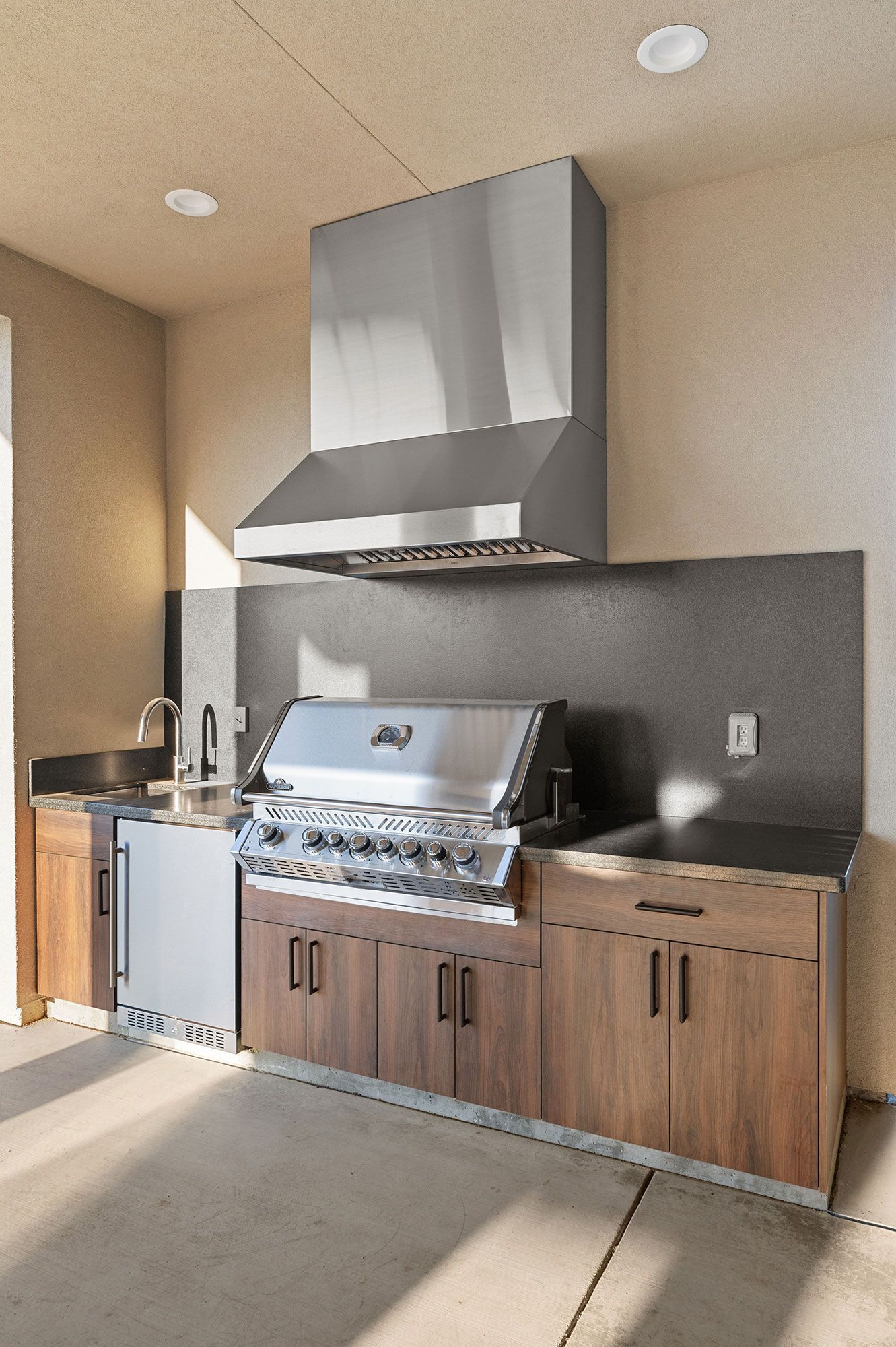 A kitchen with stainless steel appliances and wooden cabinets