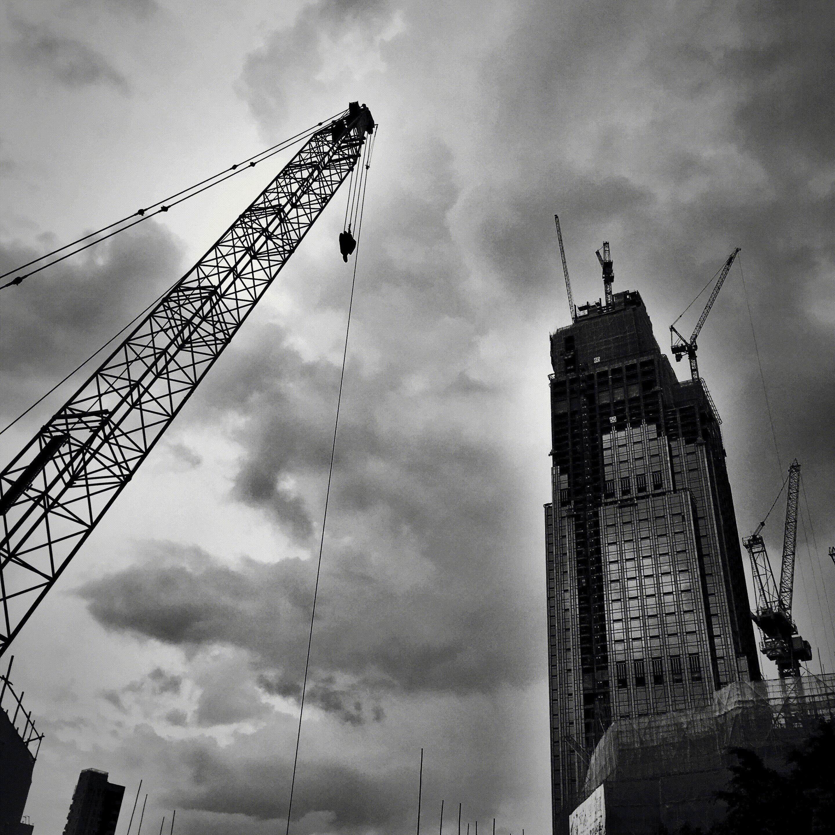A black and white photo of a building under construction