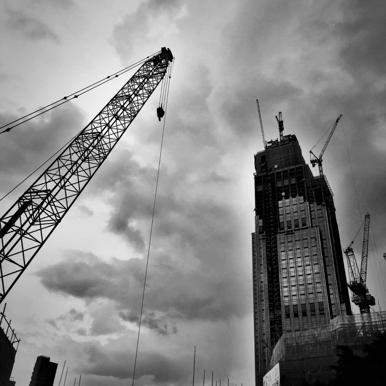 A black and white photo of a building under construction