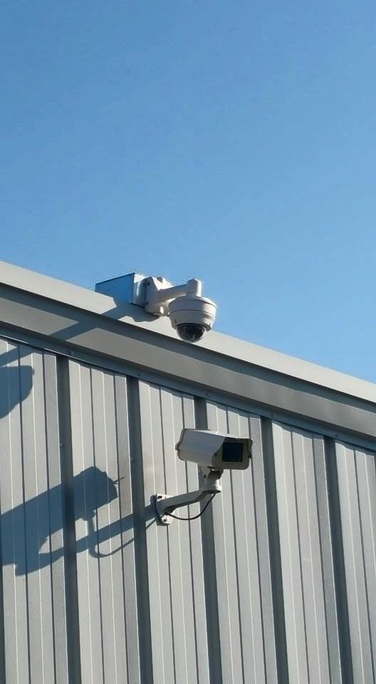 Two security cameras are mounted on the side of a building