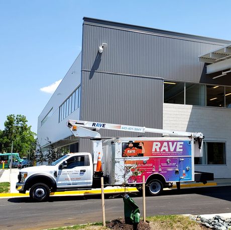 A rave truck is parked in front of a building