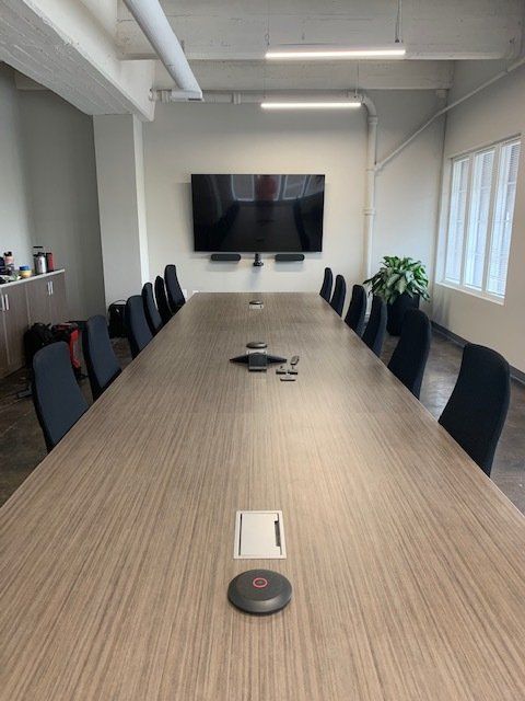A conference room with a long table and chairs