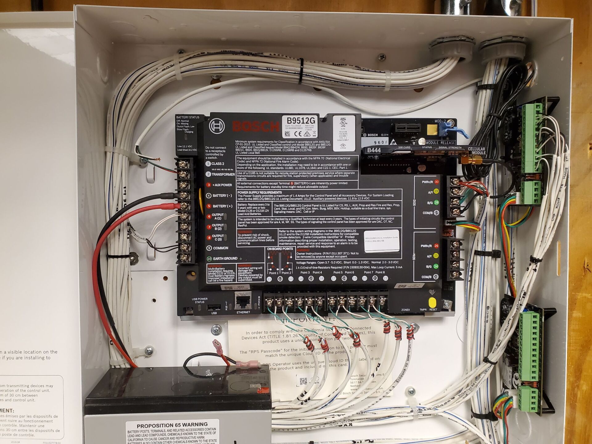 A white box with a lot of wires coming out of it