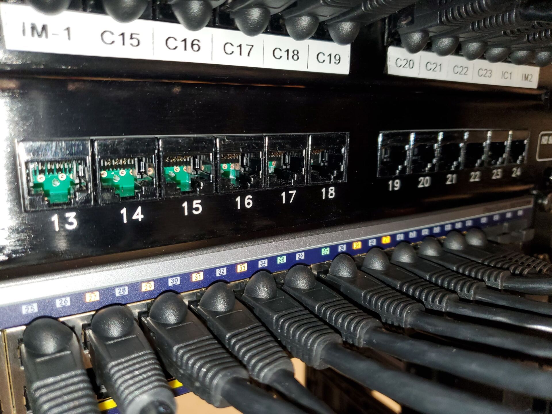 A bunch of cables are plugged into a server.