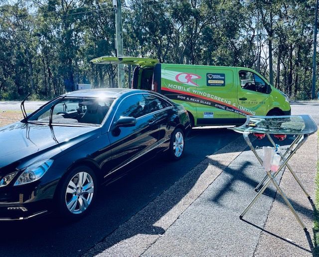 Service Van Parked Next To A Black Car — Windscreen Repair Central Coast