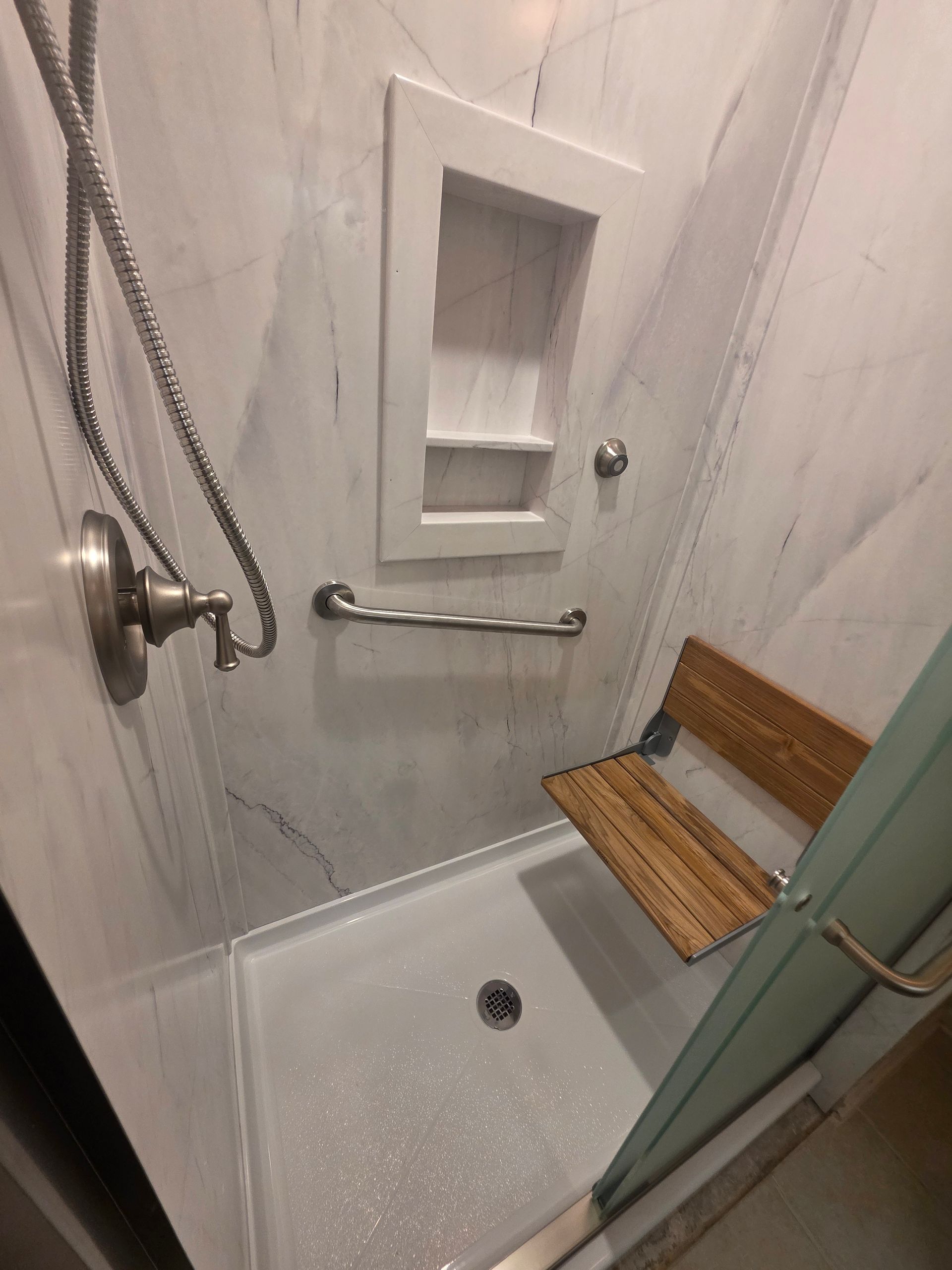 Bathroom with corner jacuzzi tub, mirrors, and a towel rack next to a toilet.