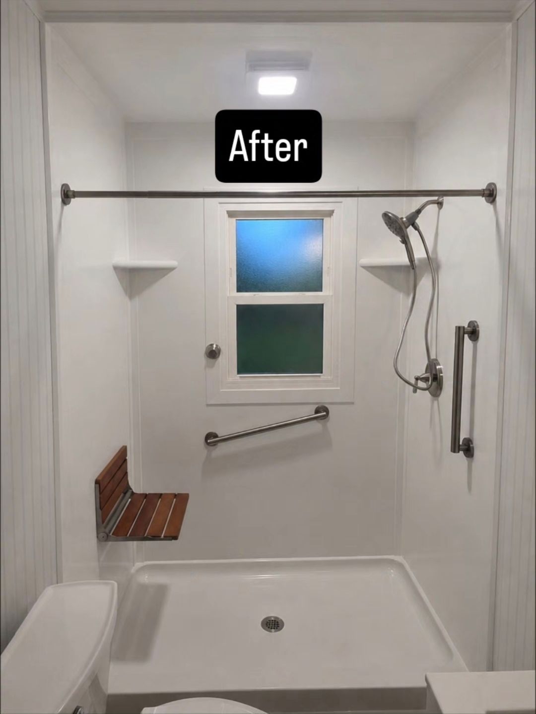 Bathroom with white cabinets, marble shower, and gray flooring.