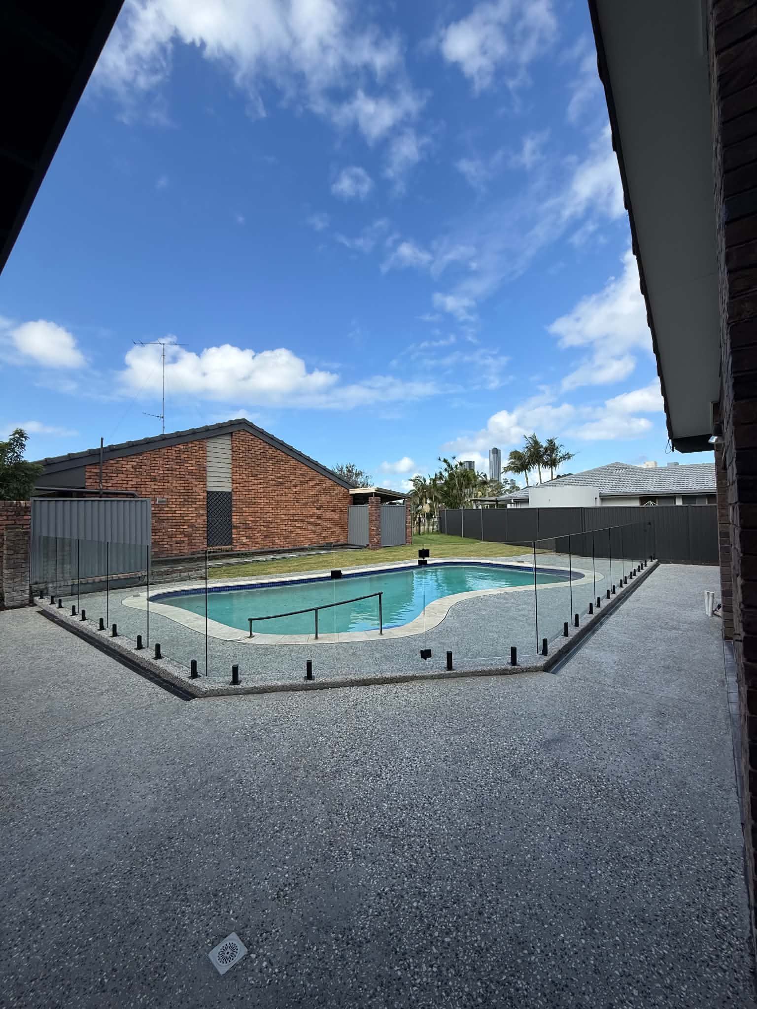 Frameless Glass Pool fencing installed around a pool on the Gold Coast 
