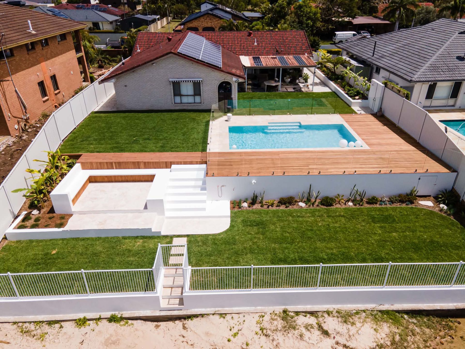 A pool area with pool fencing installed on the Gold Coast